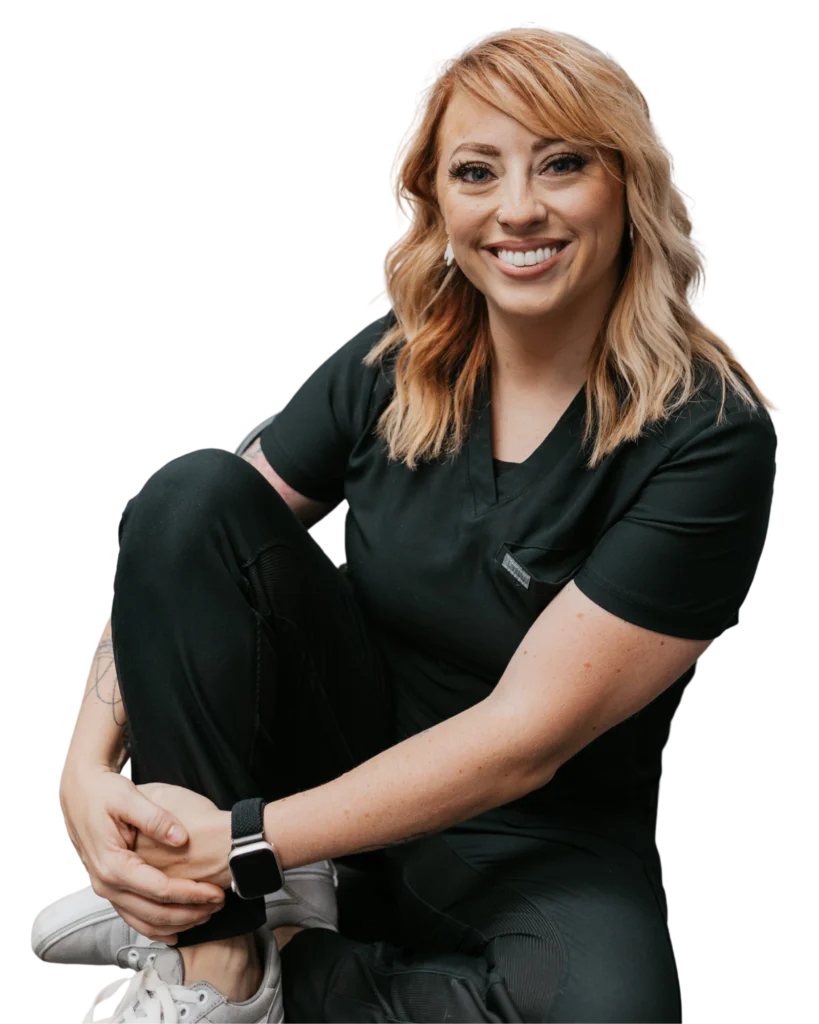 Smiling woman in black scrubs sitting cross legged on transparent background