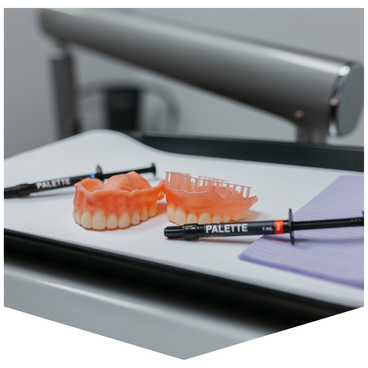 Dental dentures and shade syringes on tray in dental clinic setting